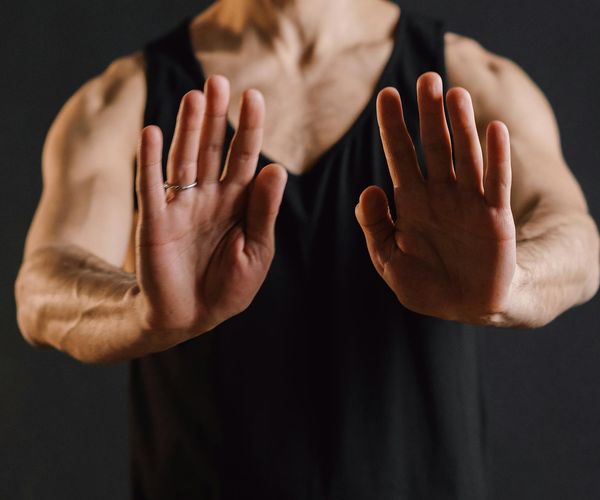Detailed view of yoga hands mudra on dark background